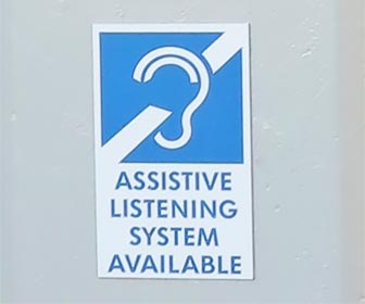 Assistive Listening System sign -- this sign is near the entrance at Dodger Stadium. [Photo Credit: LAtourist.com]