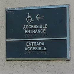 Sign indicates direction to accessible entrance at Olvera Street in downtown Los Angeles. [Photo Credit: LAtourist.com]