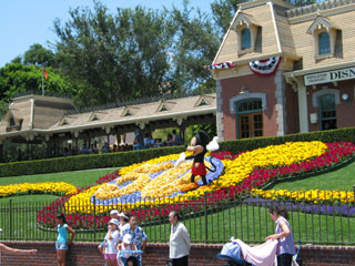 Mickey Mouse greets visitors near the entrance of Disneyland. [Photo Credit: LAtourist.com]