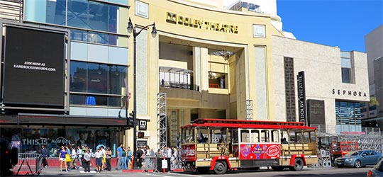 Ovation Hollywood Shopping Center, pedestrians and StarLine Tours trolley on Hollywood Boulevard. [Photo Credit: LAtourist.com]