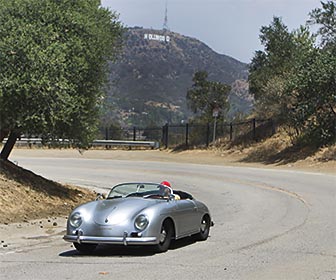 A motorist on Mulholland Drive near the Hollywood Bowl Overlook. The Hollywood Sign can be seen in the background. [Photo Credit: LAtourist.com]