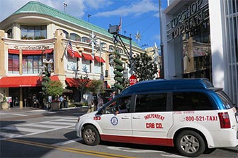 Taxi passing through the alley that separates Farmers Market from The Grove. [Photo Credit: LAtourist.com]