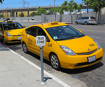 Taxis at a taxi stand in downtown Los Angeles. [Photo Credit: LAtourist.com]